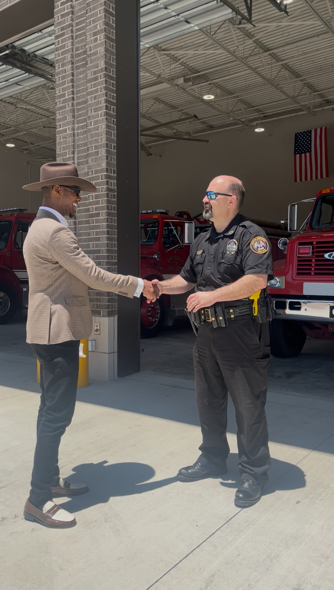 Devante Hill greeting a first responder at a Dresden fire station